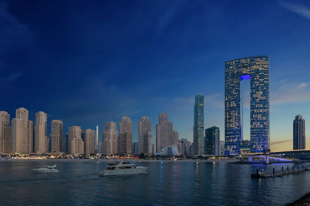 Luxury waterfront skyline at dusk with high-rise buildings and yachts.
