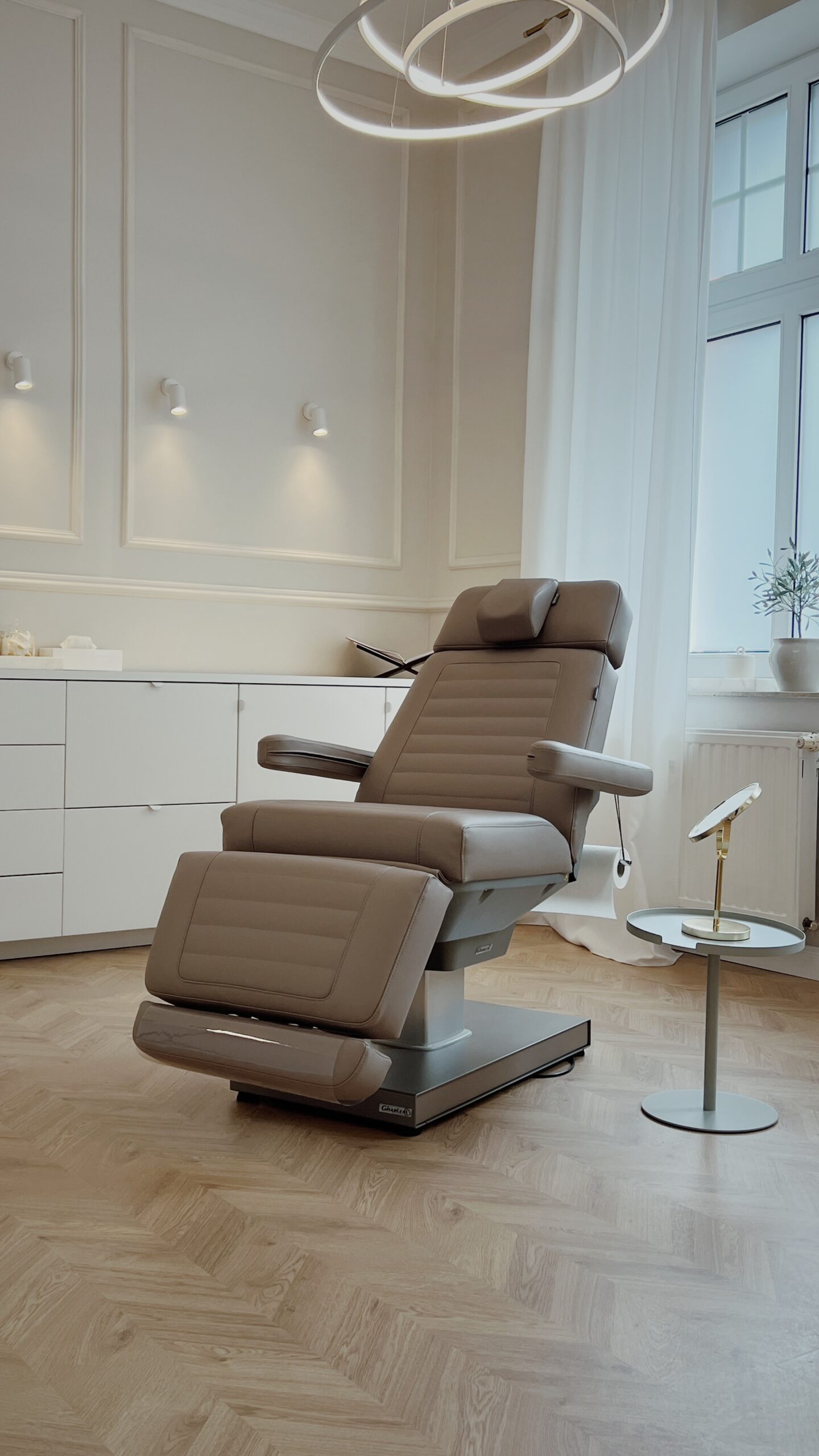 Luxurious spa treatment table in modern clinic setting, by Gharieni.