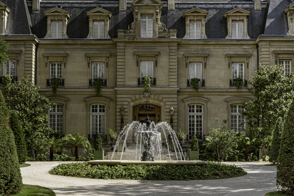 Luxurious spa retreat with elegant architecture and serene garden fountain.