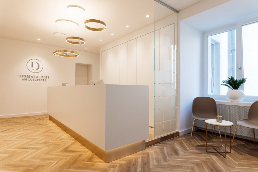 Sleek dermatology clinic reception with modern design and elegant lighting.