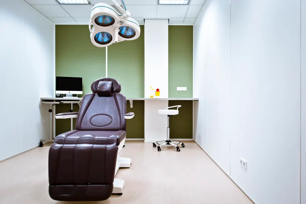 Luxurious Gharieni spa treatment table in modern, well-equipped therapy room.