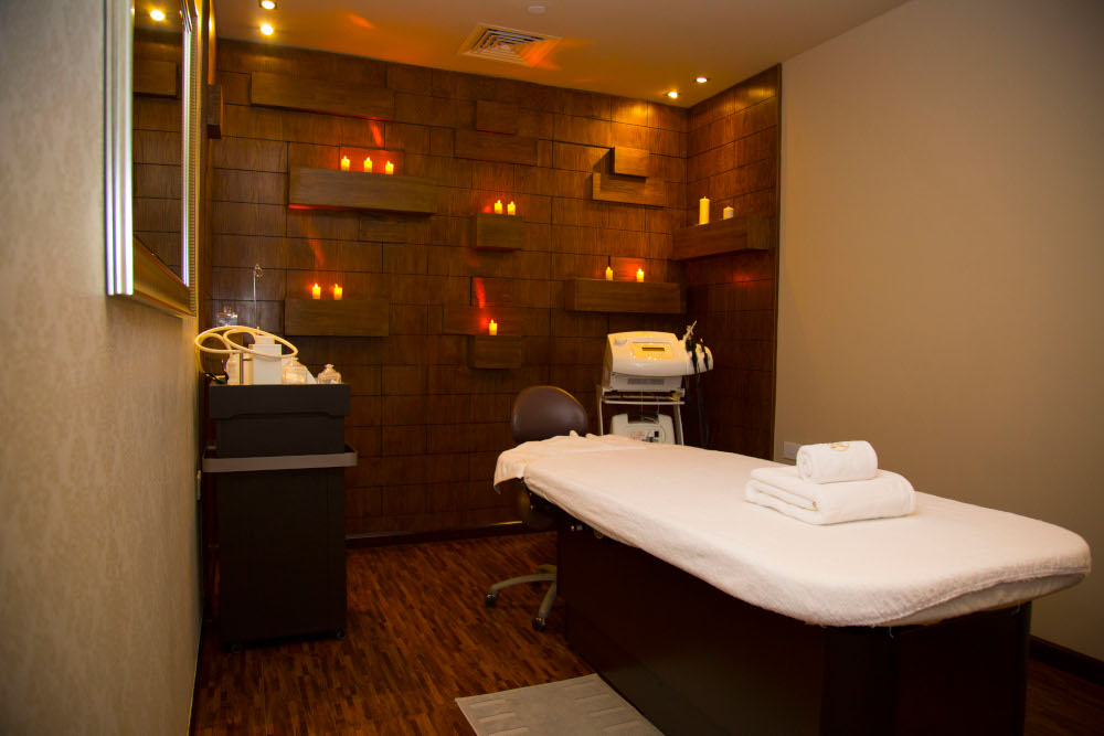 Luxurious spa room with premium treatment table, ambient lighting, and modern equipment.
