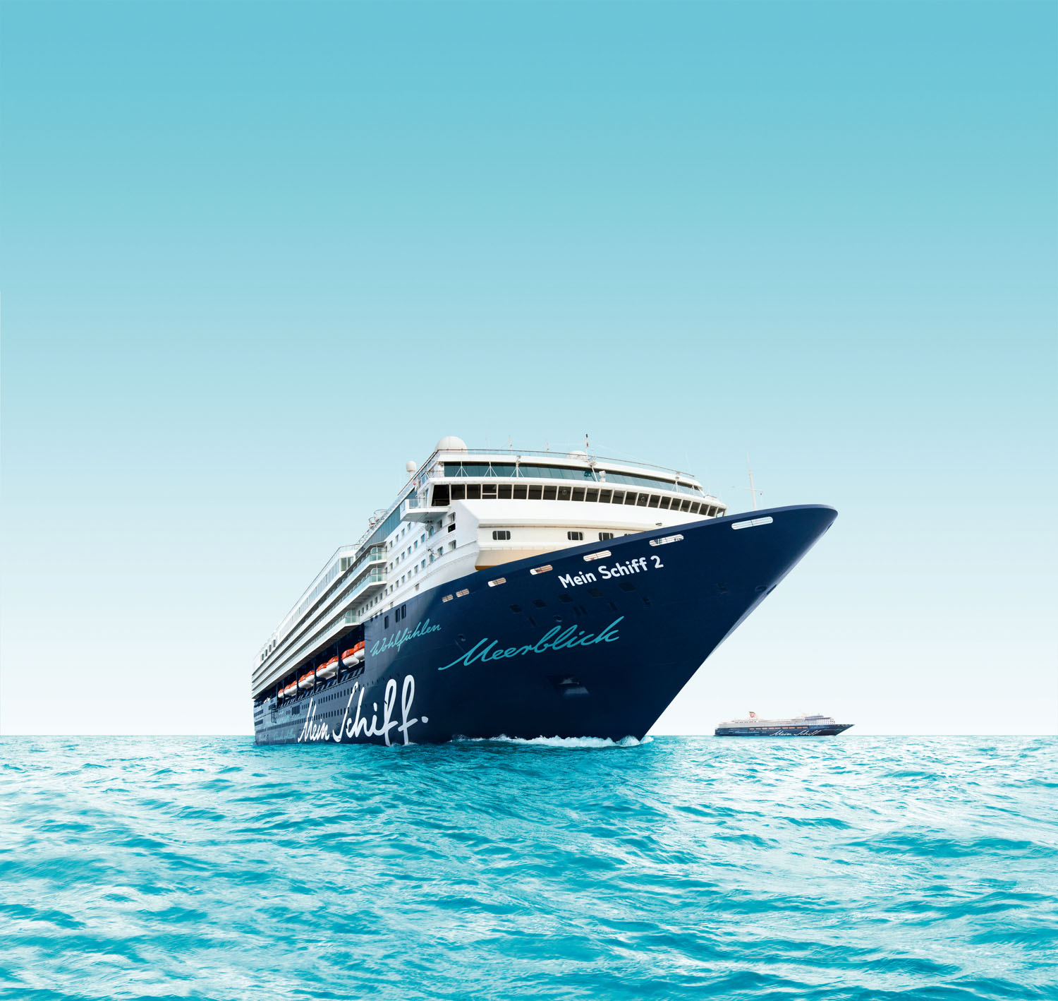 Luxurious cruise ship on turquoise ocean under clear sky.