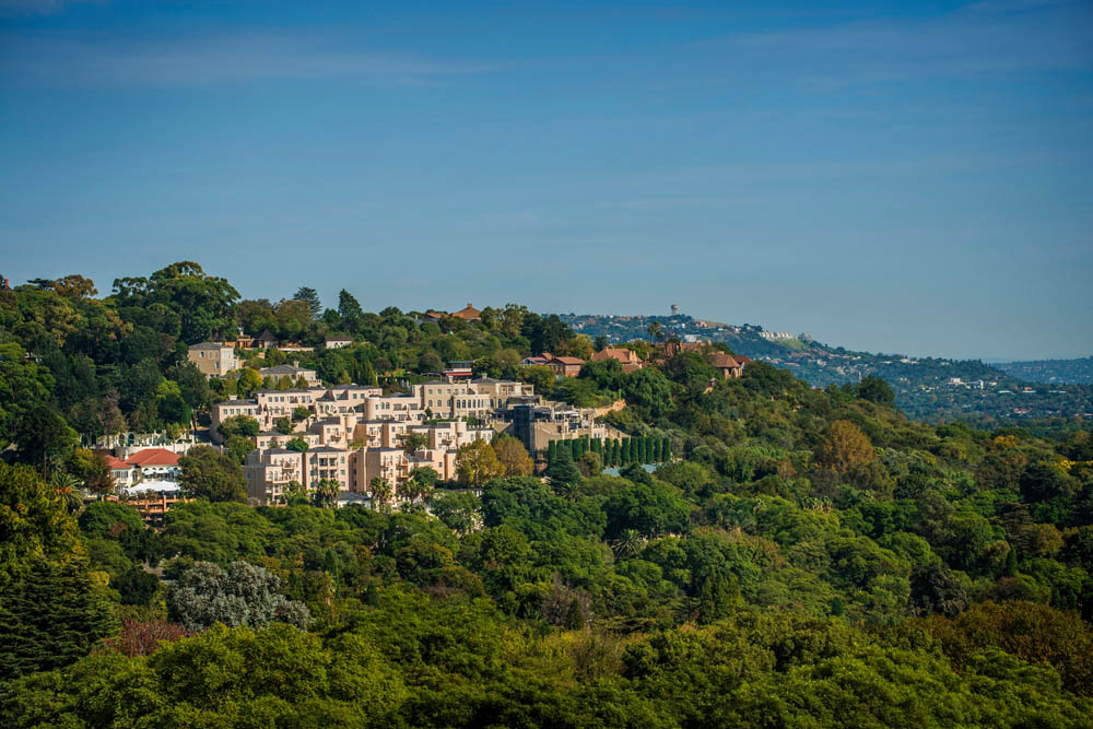 Luxurious spa retreat surrounded by lush greenery and scenic hillside views.