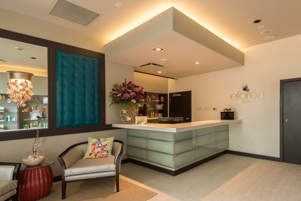 Luxurious spa reception with modern decor, plush seating, and elegant lighting.