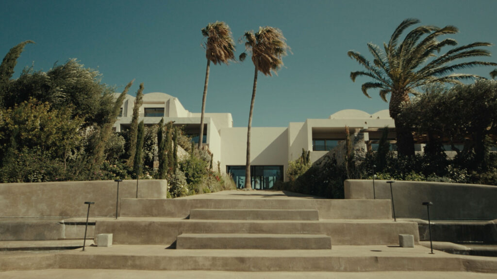 Luxurious spa entrance with palm trees, modern architecture; Gharieni premium wellness.