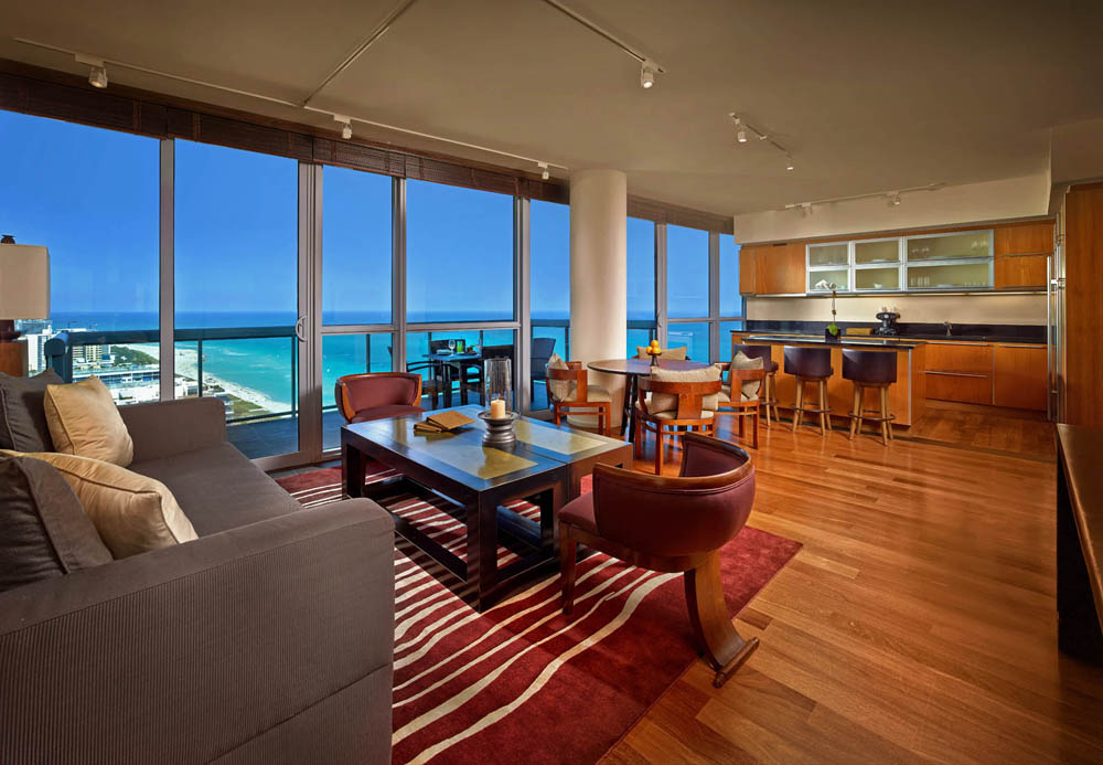Luxurious ocean-view living room with modern furniture and elegant wooden flooring.